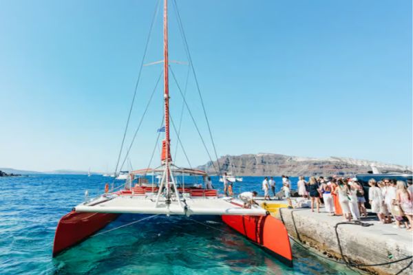 Santorini: Catamaran Tour with BBQ Dinner, Drinks, and Music